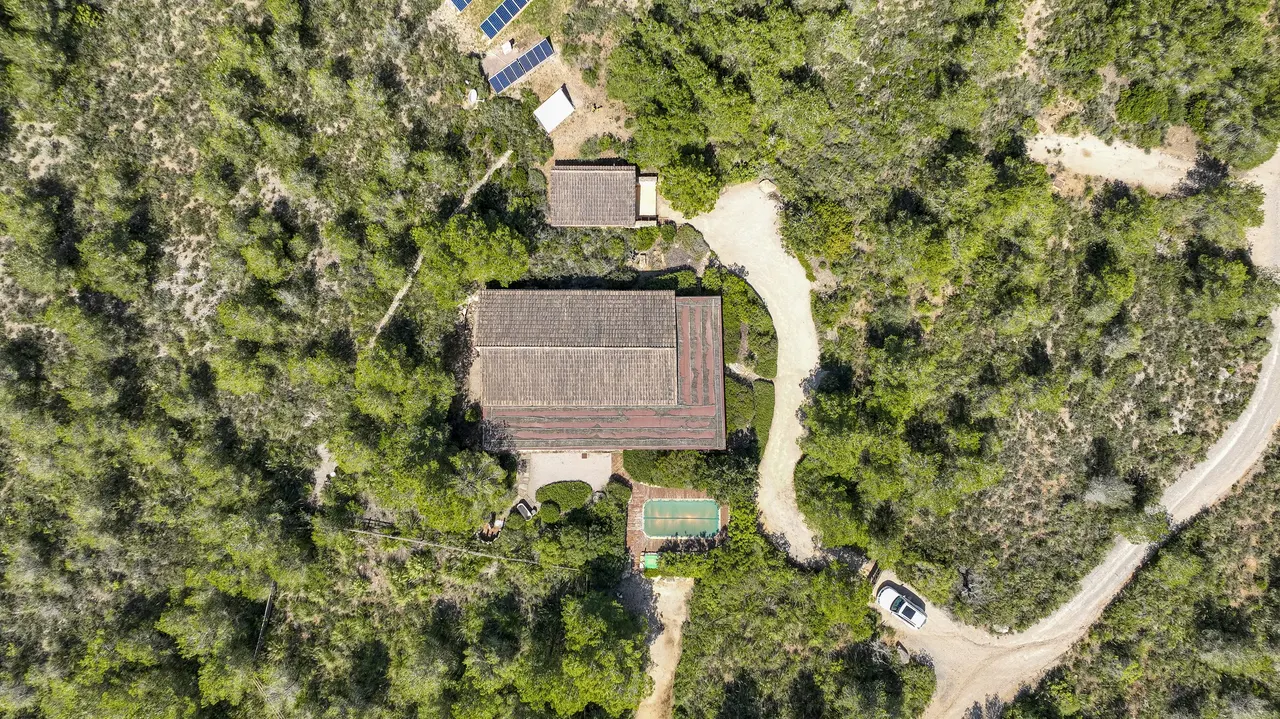 Aerial of a hidden lodge in pines